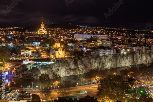 Night view of Tbilisi with Sameba (Trinity) Church and other landmarks. Travel.