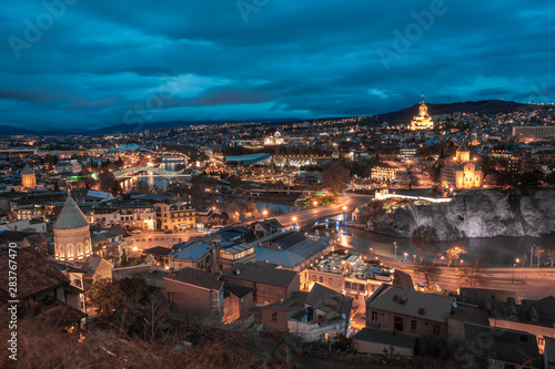 Evening view of Tbilisi with Sameba (Trinity) Church and other landmarks. Travel.