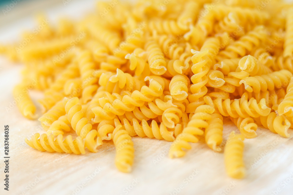 Fusilli on the wooden table. Fusilli is a type of spaghetti. Fusilli on the wooden table. Fusilli is a type of spaghetti.
