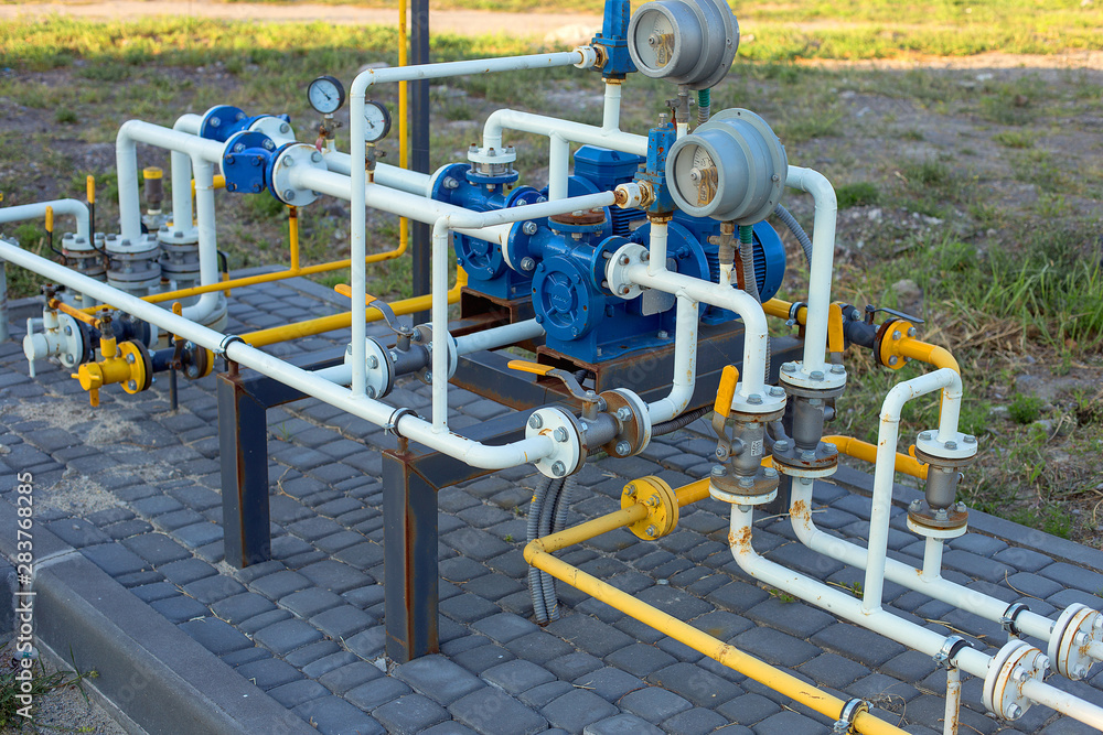 Many tangled gas pipes of different colors with pressure gauges. Gas distribution unit. Industrial industrial background. Many tangled gas pipes of different colors with pressure gauges. Gas distribution unit. Industrial industrial background.