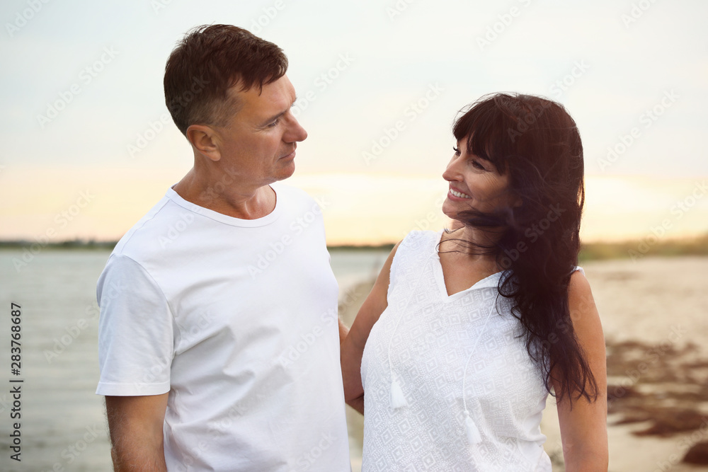 Obraz premium Happy mature couple spending time together on sea beach
