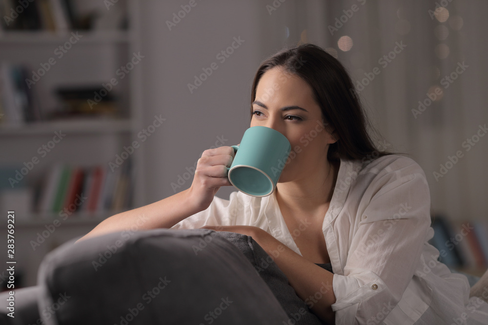 Lady drinking coffee in the night at home Lady drinking coffee in the night at home