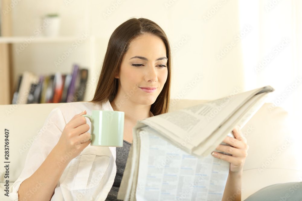 Woman at home reading a newspaper drinking coffee Woman at home reading a newspaper drinking coffee