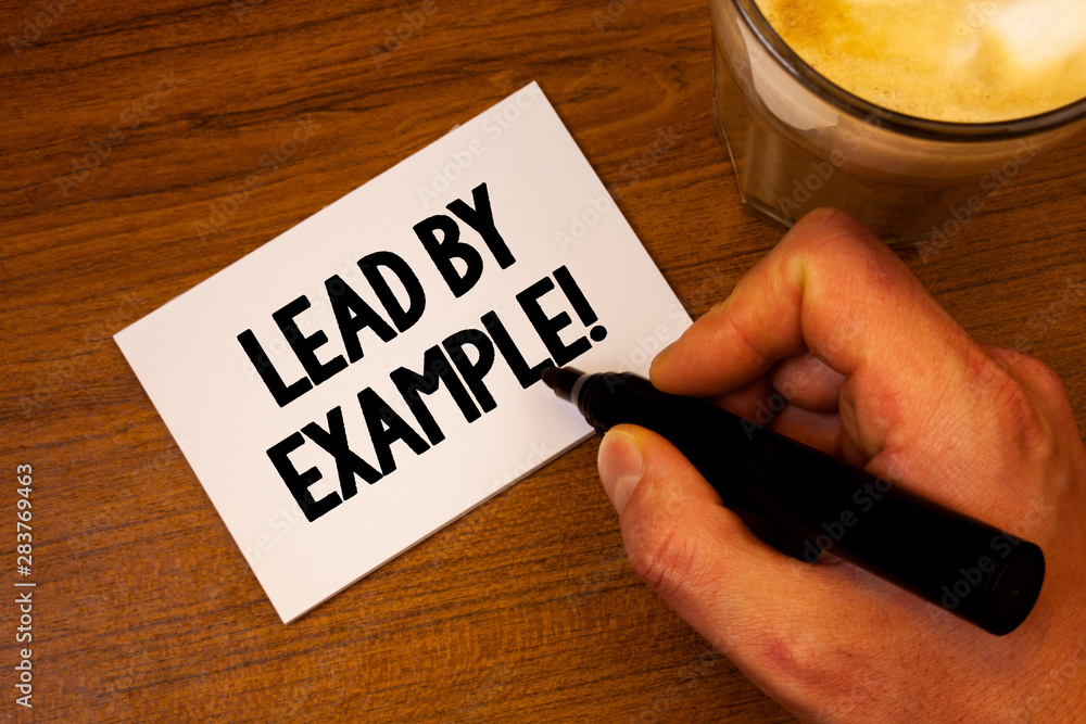 Conceptual hand writing showing Lead By Example Motivational Call. Business photo text Leadership Management Mentor Organization Text white paper hand black marker coffee glass letter Conceptual hand writing showing Lead By Example Motivational Call. Business photo text Leadership Management Mentor Organization Text white paper hand black marker coffee glass letter