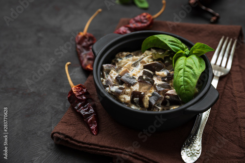 Eggplant curry on dark wooden background. Healthy food concept