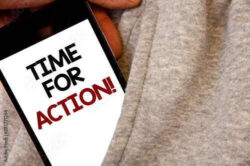 Text sign showing Time For Action Motivational Call. Conceptual photo Urgency Move Encouragement Challenge Work Words written black Phone white Screen Hand holding pocket white tracksuit