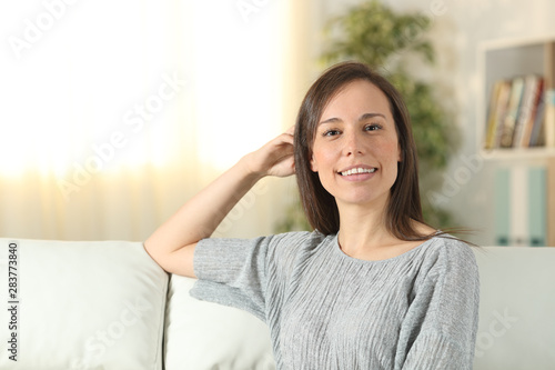 Happy confident woman looks at camera at home