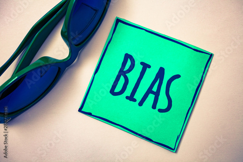 Word writing text Bias. Business concept for Unfair Subjective One-sidedness Preconception Inequality Bigotry Green paper beige background sunglasses ideas messages feelings thoughts photo