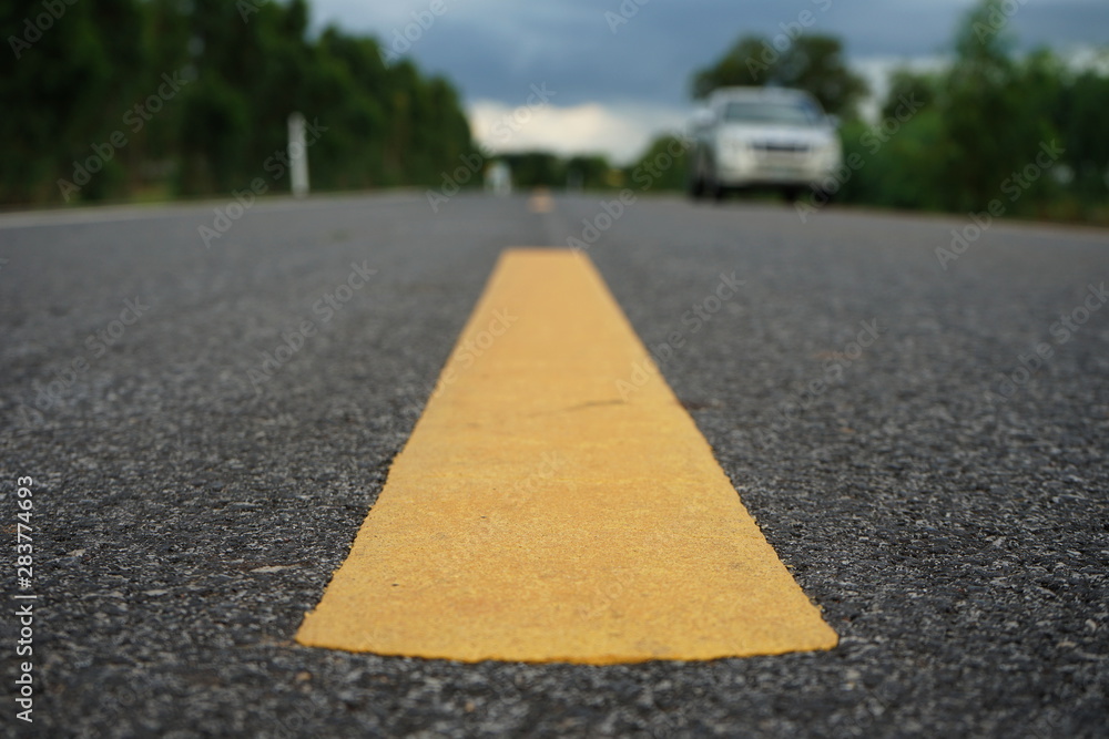 Obraz premium Road traffic paint Yellow on the asphalt surface