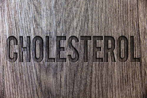 Conceptual hand writing showing Cholesterol. Business photo showcasing Low Density Lipoprotein High Density Lipoprotein Fat Overweight Wooden background vintage wood board message ideas feelings