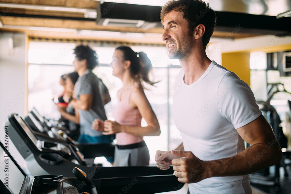 Fit people running in machine treadmill at fitness gym Fit people running in machine treadmill at fitness gym
