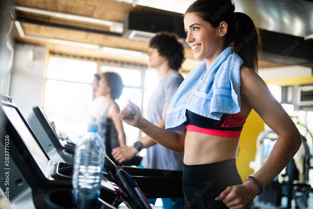 Beautiful fit people exercising together in gym Beautiful fit people exercising together in gym