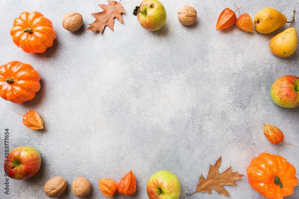 Autumn background with yellow leaves, pumpkins apples pears and nuts. Copy space. Autumn background with yellow leaves, pumpkins apples pears and nuts. Copy space.