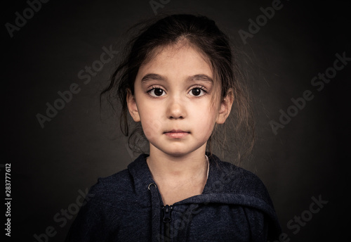 Shooting in the Studio. Portrait of a girl in a jacket with a hood.