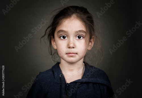 Shooting in the Studio. Portrait of a girl in a jacket with a hood.