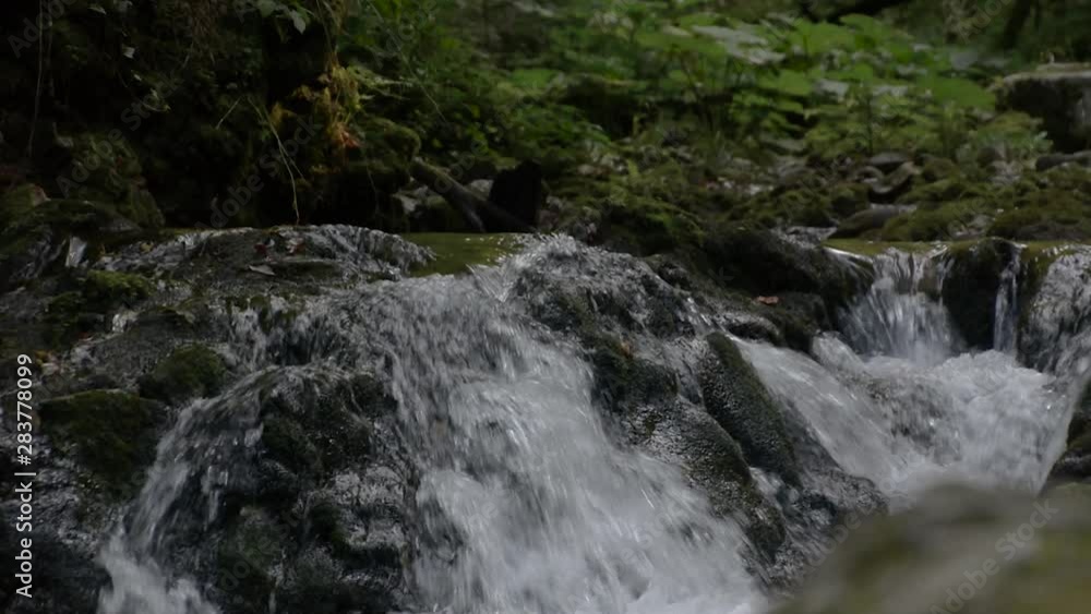 Waterfall stream of fresh water in scenic pristine natural environment Waterfall stream of fresh water in scenic pristine natural environment