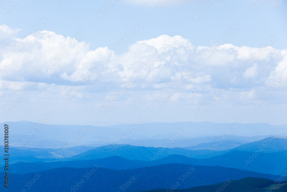 Mountain landscape with blue sky and clouds. Background.