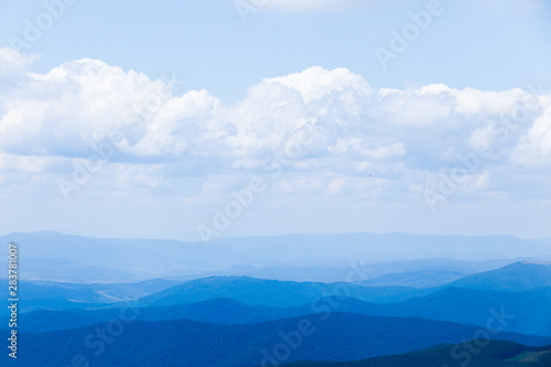 Mountain landscape with blue sky and clouds. Background.