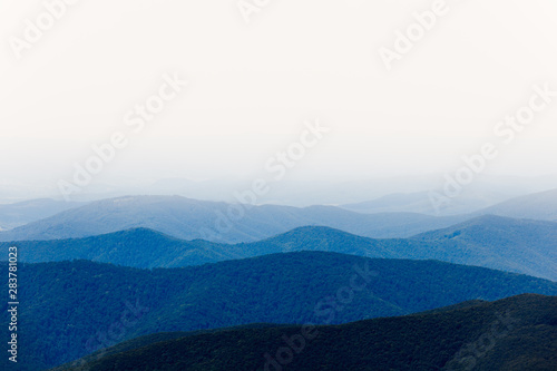 Mountain view with blue hills and white sky in the fog