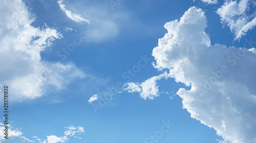 Strange and beautiful clouds in a clear blue sky on a bright sunny day.