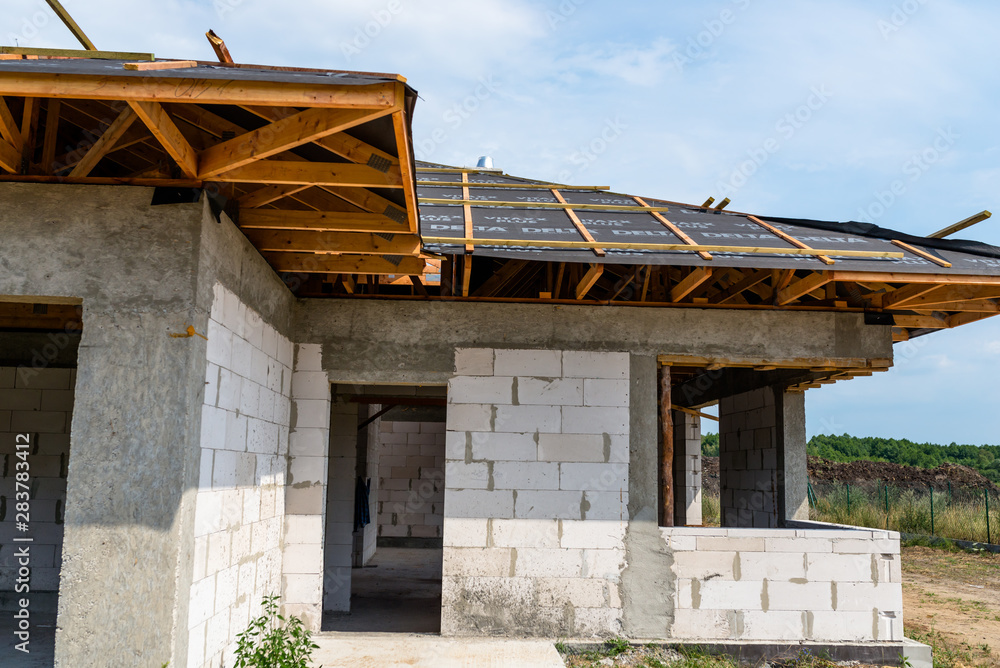 Roof trusses covered with a membrane on a detached house under construction, visible roof elements, battens, counter battens, rafters. Roof trusses covered with a membrane on a detached house under construction, visible roof elements, battens, counter battens, rafters.