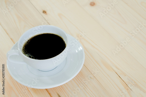 Black coffee cup on wood background