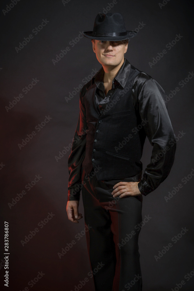 Beautiful man in black on a black background, best men, headgear Beautiful man in black on a black background, best men, headgear