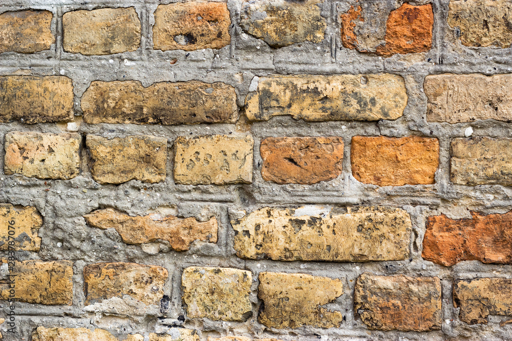 Weathered ancient red brick wall, antique medieval castle brick wall architecture orange brown decorative plaster aging medieval old bricks material Weathered ancient red brick wall, antique medieval castle brick wall architecture orange brown decorative plaster aging medieval old bricks material