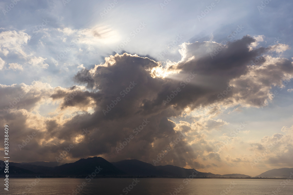 Sunlight through the clouds at dawn, island Koh Samui, Thailand Sunlight through the clouds at dawn, island Koh Samui, Thailand