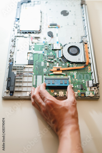 hand of repairman holding a ram sodimm memory module, laptop upgrade