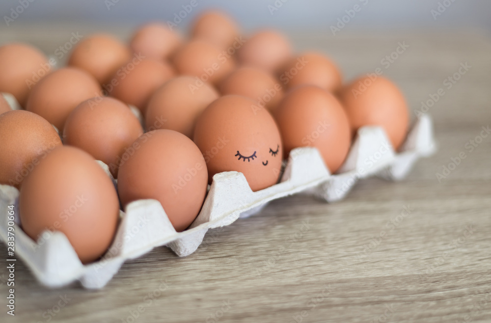 Egg with happy face in the basket with other eggs. Egg with happy face in the basket with other eggs.