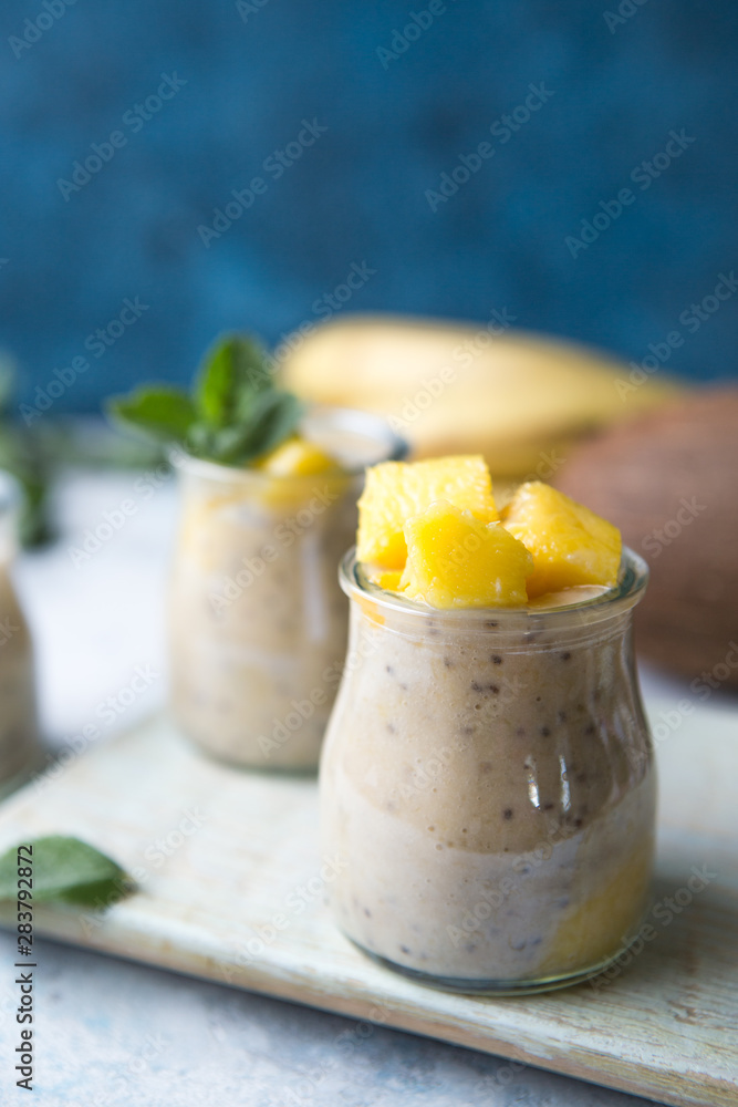 Beautiful and tasty dessert with mango and seeds of a chia. A fresh pudding with fruit for breakfast Beautiful and tasty dessert with mango and seeds of a chia. A fresh pudding with fruit for breakfast