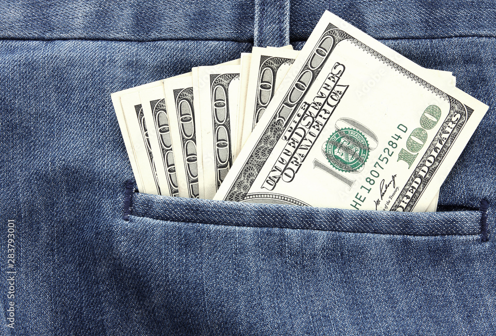 Closeup dollars in a jeans pocket Closeup dollars in a jeans pocket