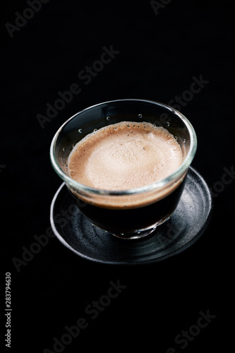 Cup of espresso on black background. Copy space. 