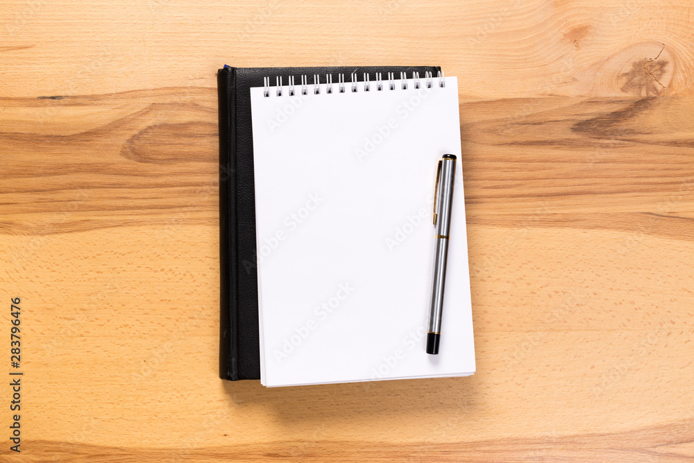 school notepad and pen on the wooden desk. spiral notepad on a tableschool notepad and pen on the wooden desk. spiral notepad on a table school notepad and pen on the wooden desk. spiral notepad on a tableschool notepad and pen on the wooden desk. spiral notepad on a table