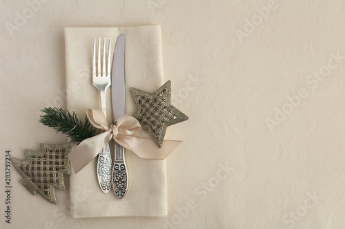 Christmas table setting on the beige tablecloth. Top view. Copy space.