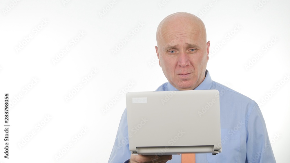 Serious Businessman Image Reading Bad Financial News on Laptop Serious Businessman Image Reading Bad Financial News on Laptop