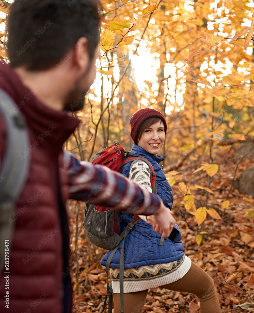 POV picture of an attractive caucasian couple hiking through the forest in the fall in Canada