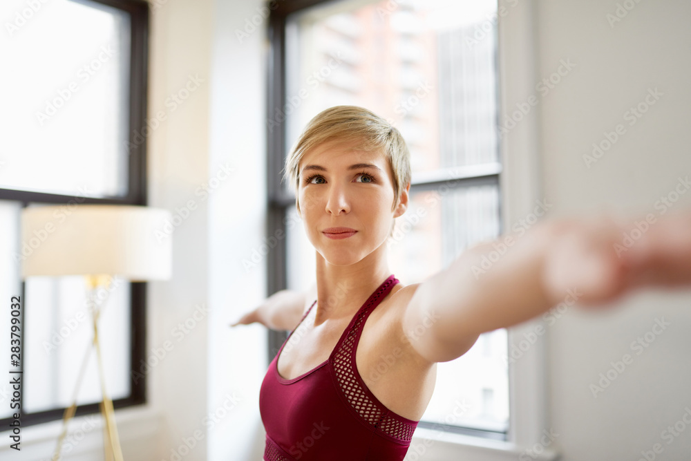 Trendy woman doing yoga as part of her mindfulness morning routine Trendy woman doing yoga as part of her mindfulness morning routine