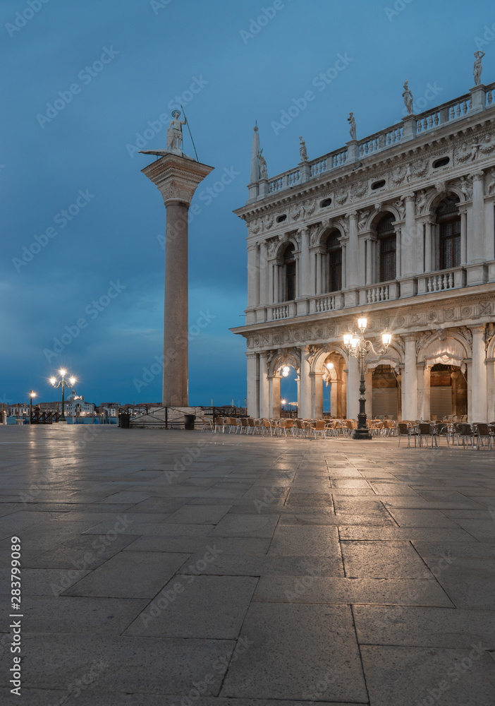 Column of St. Theodore in St. Mark's Square in Vinice by the light of night lanterns