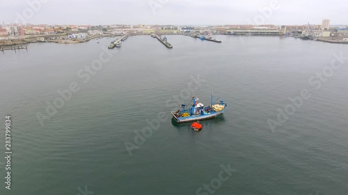 Wallpaper Mural Aerial, drone shot, tilting up overlooking a fishing boat and a emergency boat, on the coast of Peniche, on a cloudy, summer day, in Portugal Torontodigital.ca