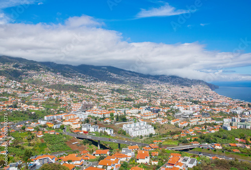 Funchal and Atlantic ocean panormic view from The Pico dos Barcelos Viewpoin (MIRADOURO PICO DOS BARCELOS) in Funchal city, Madeira island, Portugal in summer sunny day 