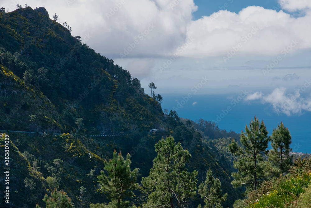 Panoramic mountains view from Eira do Serrado viewpoint down to The Atlantic ocean and Funchal city. Madeira Island in summer