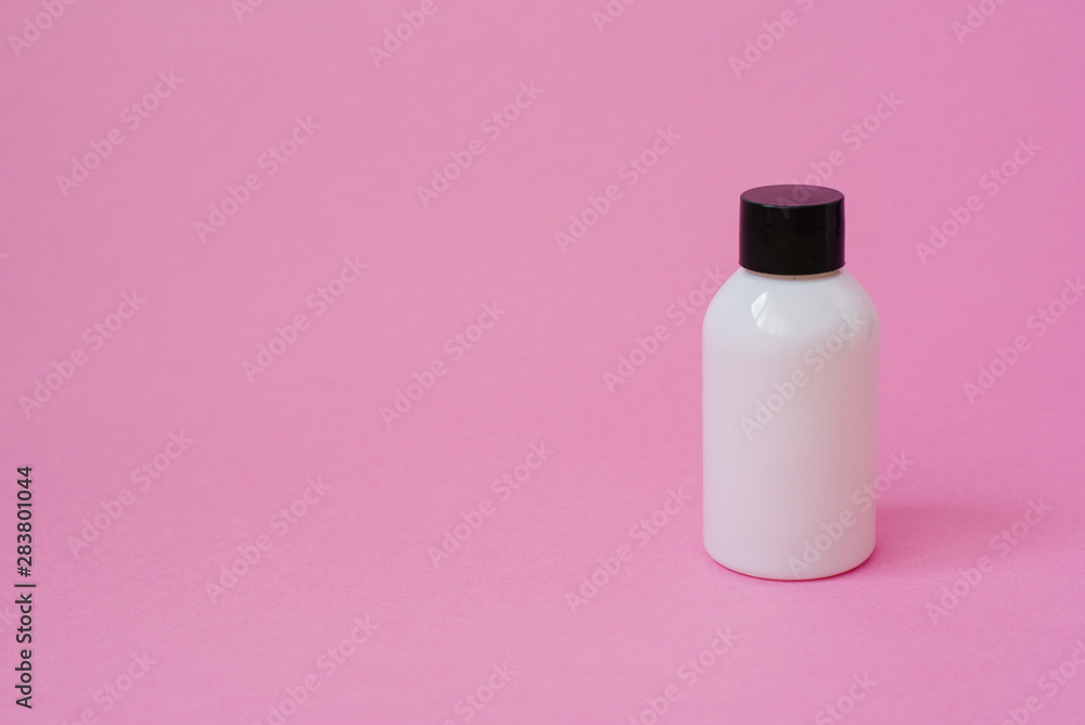 Cosmetic product bottle white with black cap for body skin care cosmetics or hair on pink background. side view with copy space, banner or template. The concept of beauty product. Blank label Cosmetic product bottle white with black cap for body skin care cosmetics or hair on pink background. side view with copy space, banner or template. The concept of beauty product. Blank label