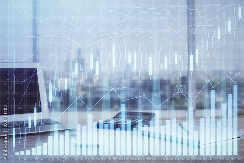 Stock market chart hologram drawn on personal computer background. Multi exposure. Concept of investment. Stock market chart hologram drawn on personal computer background. Multi exposure. Concept of investment.