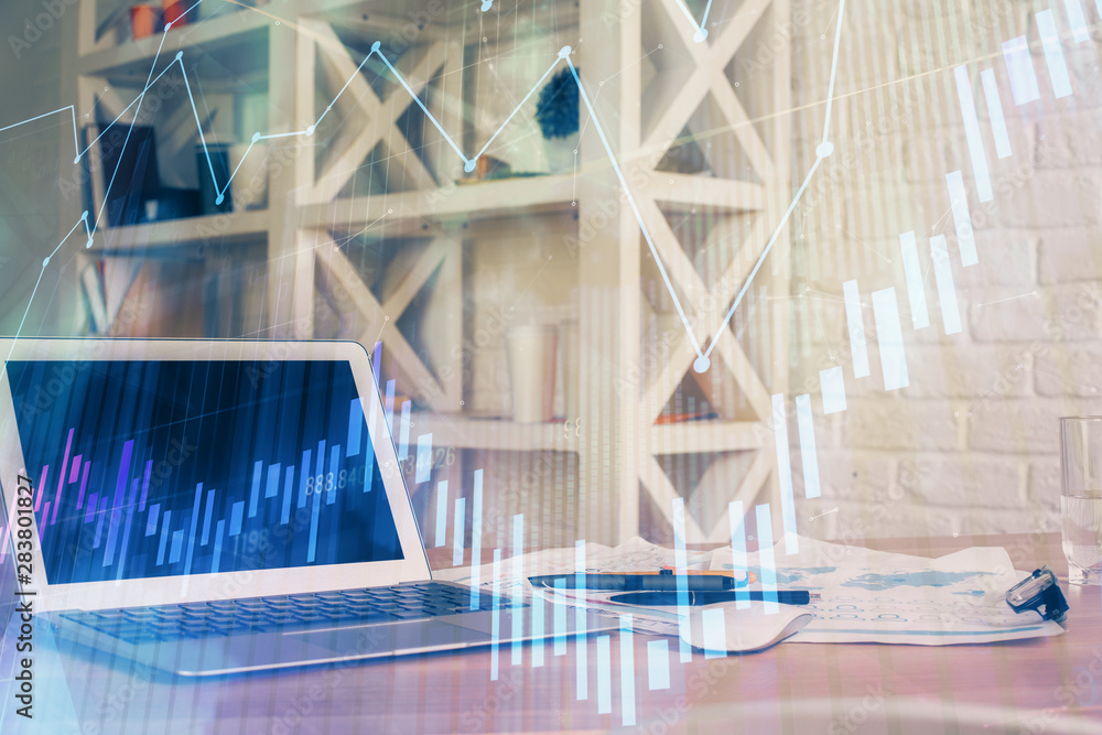 Fototapeta premium Financial chart drawing and table with computer on background. Double exposure. Concept of international markets.