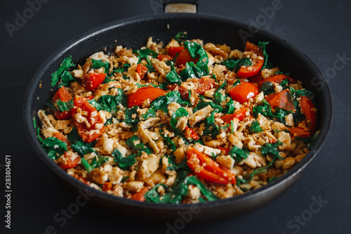 Close up of Texas Caviar: delicious one pan fried vegetable mix with tofu, low fat, vegetarian, on a black background, top view. Place for text.