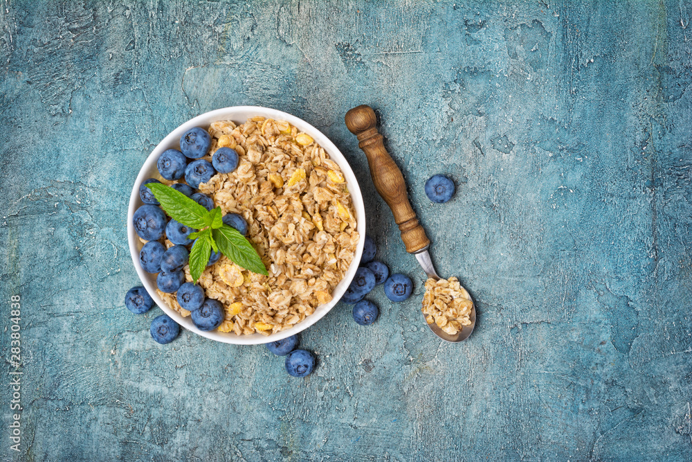 Fototapeta premium Oat flakes or granola with fresh blueberry for healthy breakfast
