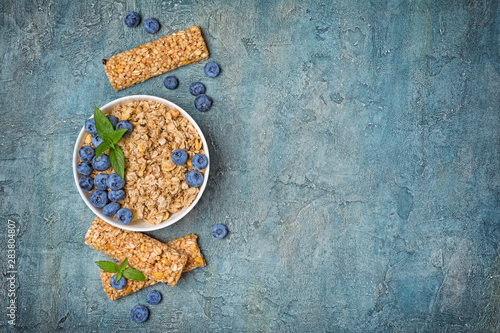 Oat flakes with fresh blueberry and granola bar for healthy breakfast