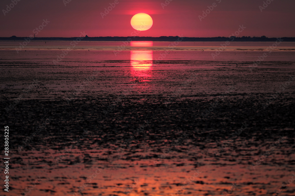 Sunset over the wadden sea and the german island spiekeroog - Stockphoto Sunset over the wadden sea and the german island spiekeroog - Stockphoto